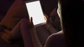 Imagen referencial de una persona mirando la tablet en la noche. (Freepik)