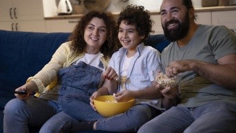 Imagen referencial de una familia mirando una película en casa. (Freepik)
