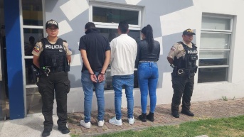 Los tres sospechosos detenidos junto a los agentes de la Policía Nacional. (Cortesía de la Policía Nacional)