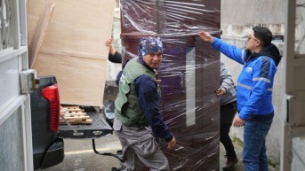 Los técnicos del Municipio entregando los enseres a los damnificados. (Cortesía de Quito Informa)