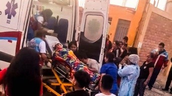 Un niño siendo trasladado al hospital por ser herido por las balas en el evento la Chocolatada, en Perú. (Redes sociales)