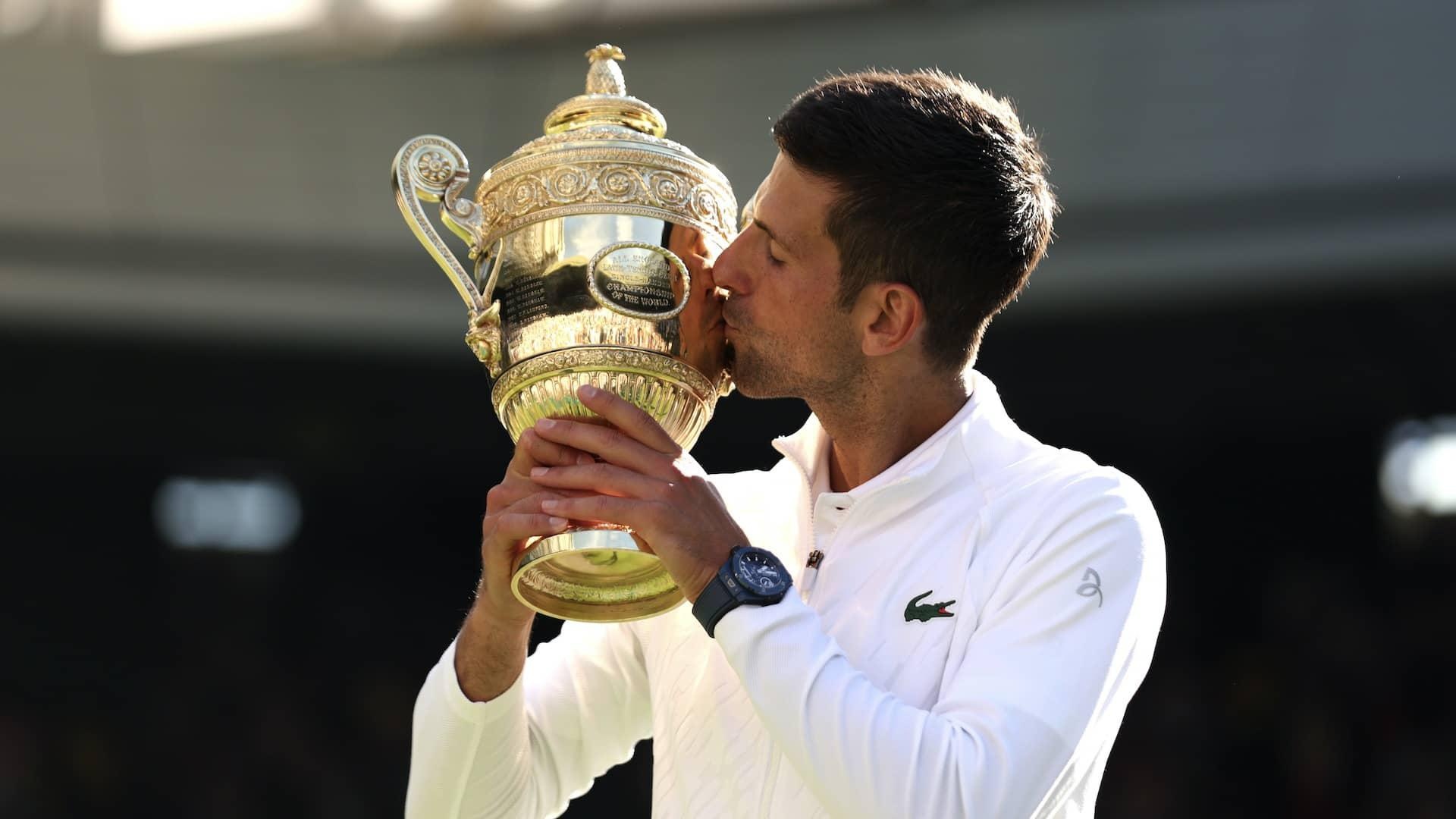 LONDON, ENGLAND - JULY 10: Novak Djokovic of Serbia kisses the trophy following his victory against Nick Kyrgios of Australia during their Men's Singles Final match on day fourteen of The Championships Wimbledon 2022 at All England Lawn Tennis and Croquet Club on July 10, 2022 in London, England. (Photo by Clive Brunskill/Getty Images) (Clive Brunskill / Getty Images)